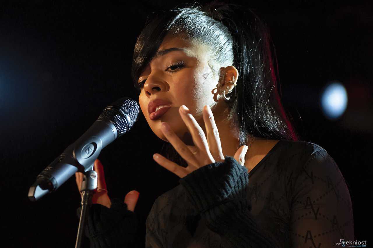 Sängerin performt emotional am Mikrofon.