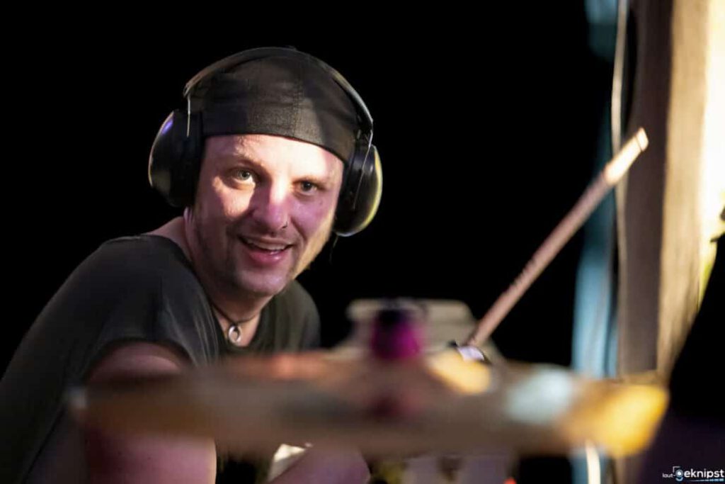 Schlagzeuger lächelt beim Spielen.