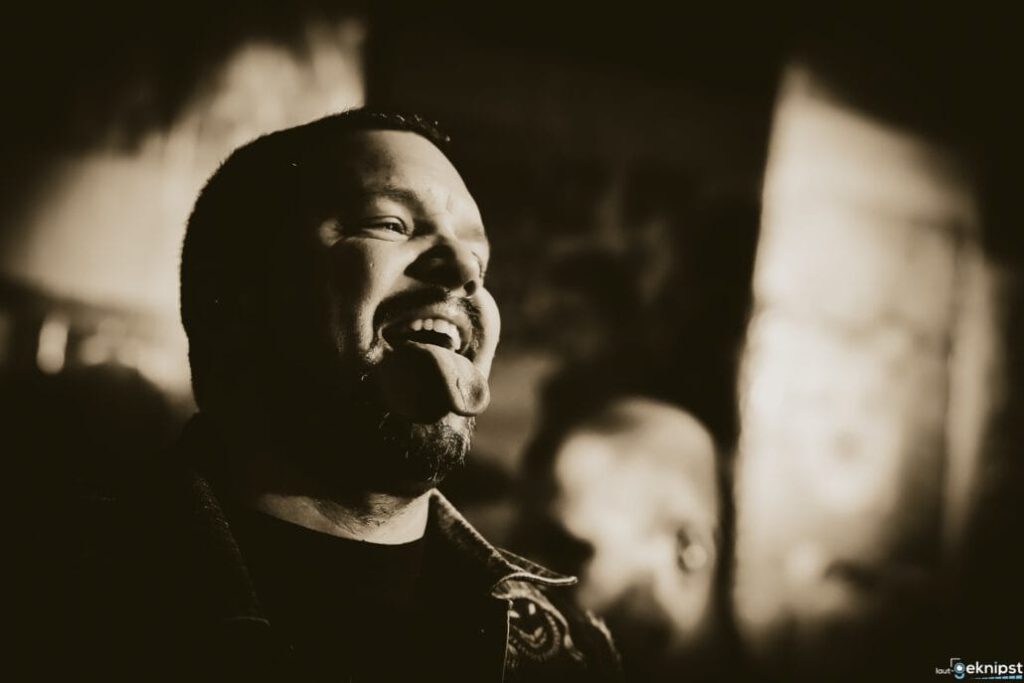 Lachender Mann in Schwarz-Weiß Fotografie.