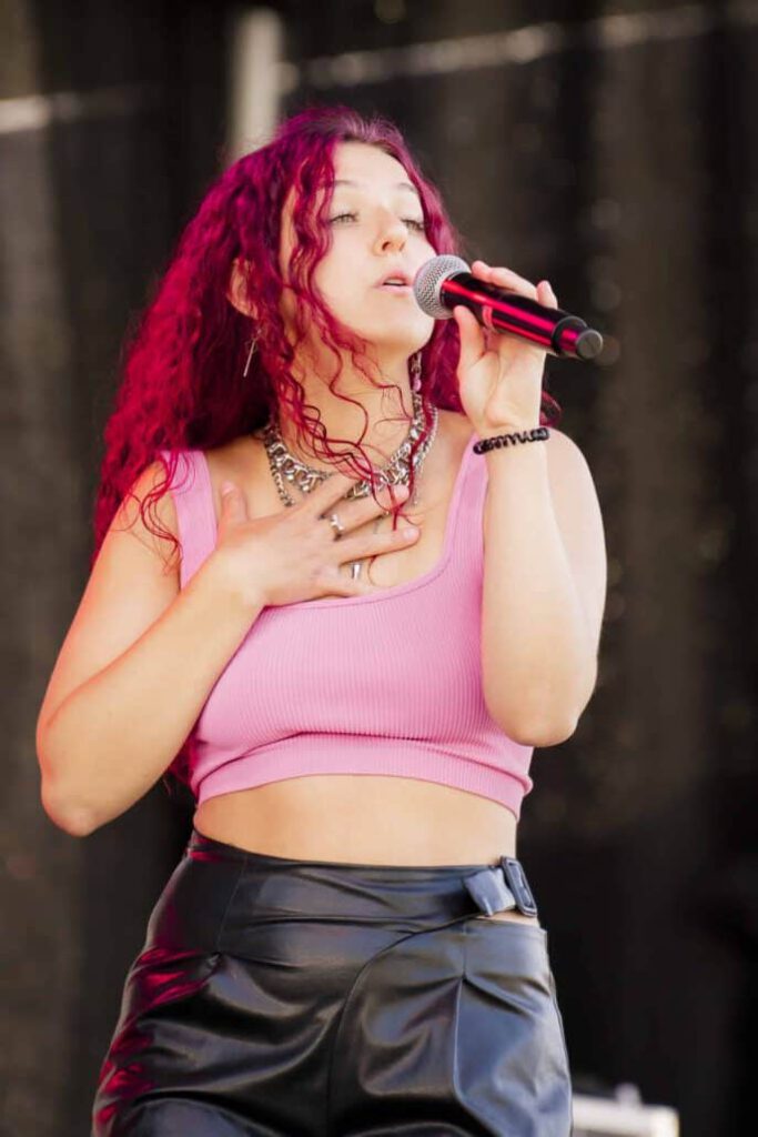 Sängerin mit rotem Haar performt live.