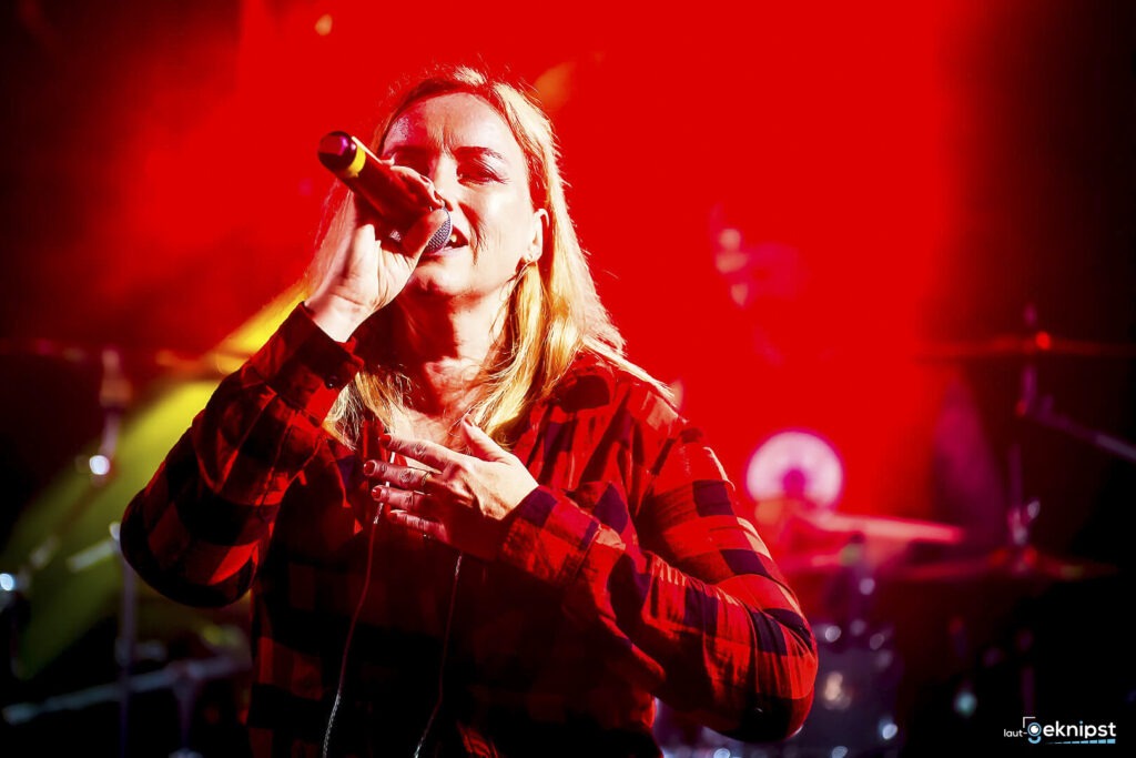Sängerin singt auf roter Bühne