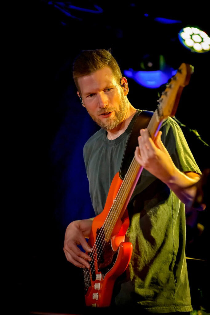 Person spielt Bass auf Bühne