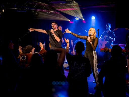 Konzert mit Sänger und Band auf der Bühne.