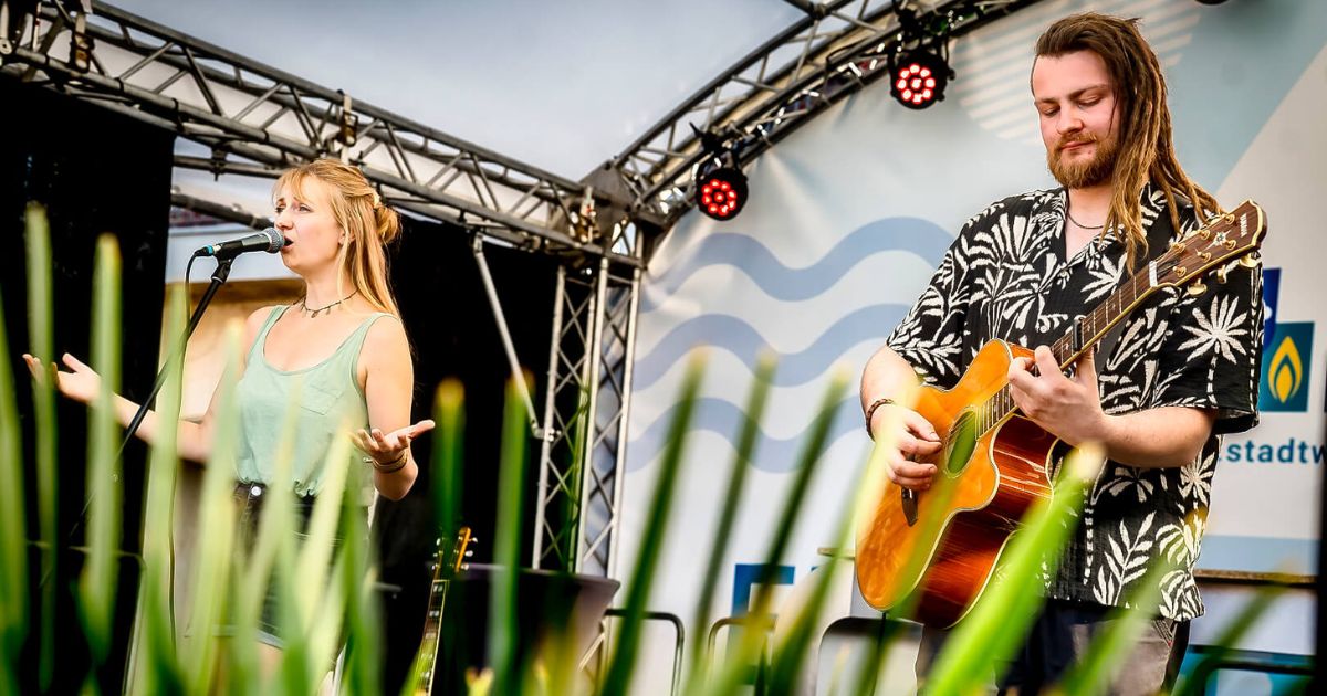 Lena und Tom von More than Us performen auf einer Bühne