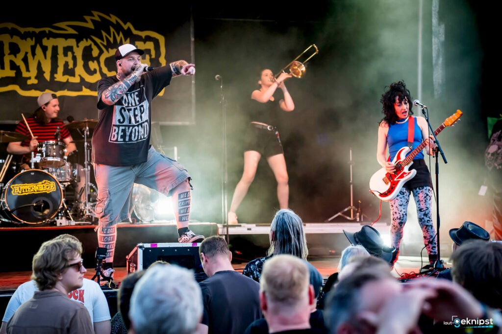 Band spielt auf Konzertbühne vor Publikum.