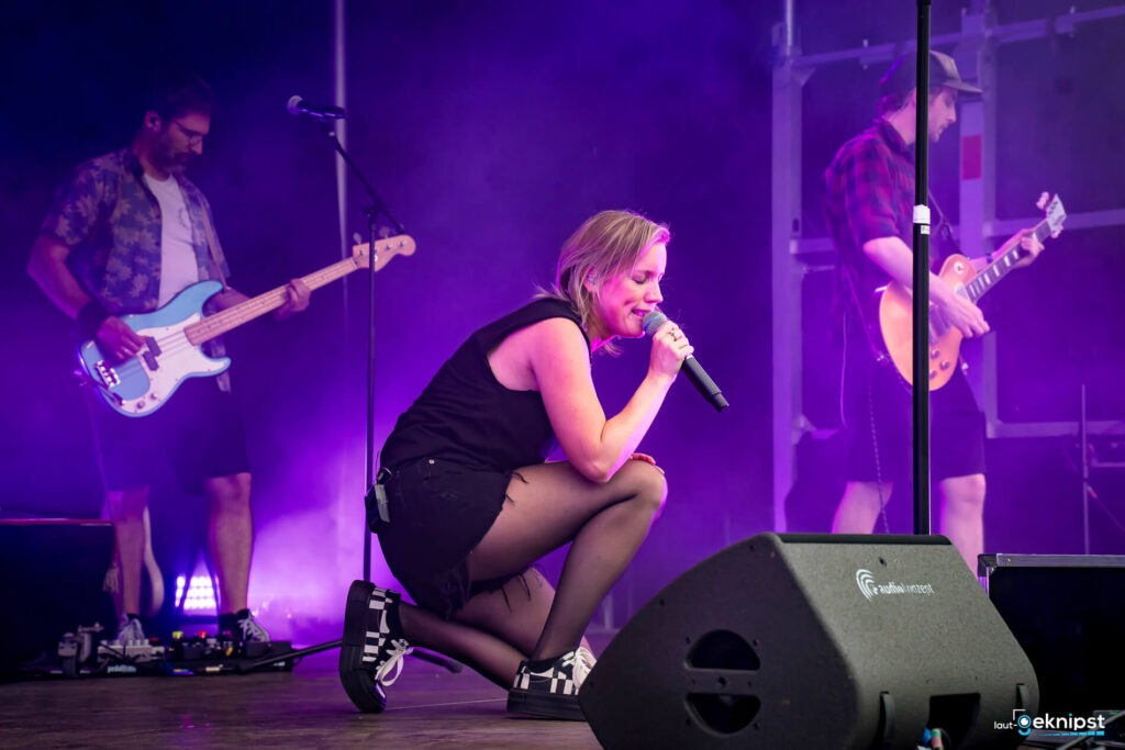 Band auf der Bühne mit Sängerin im Vordergrund