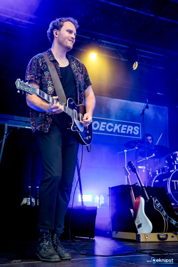Musiker spielt E-Gitarre auf einer Bühne