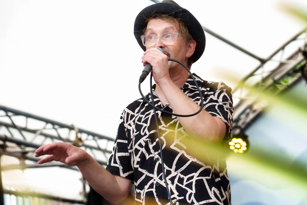 Mann mit Hut singt auf Bühne