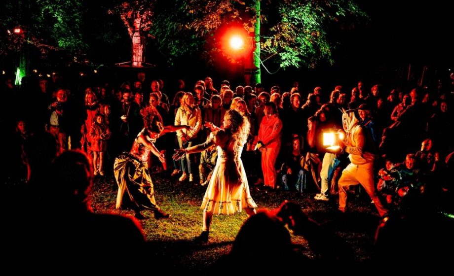 Nachtperformance mit Publikum im Freien, bunte Beleuchtung