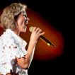 Anna Maria Zimmermann singt mit Mikrofon auf Bühne