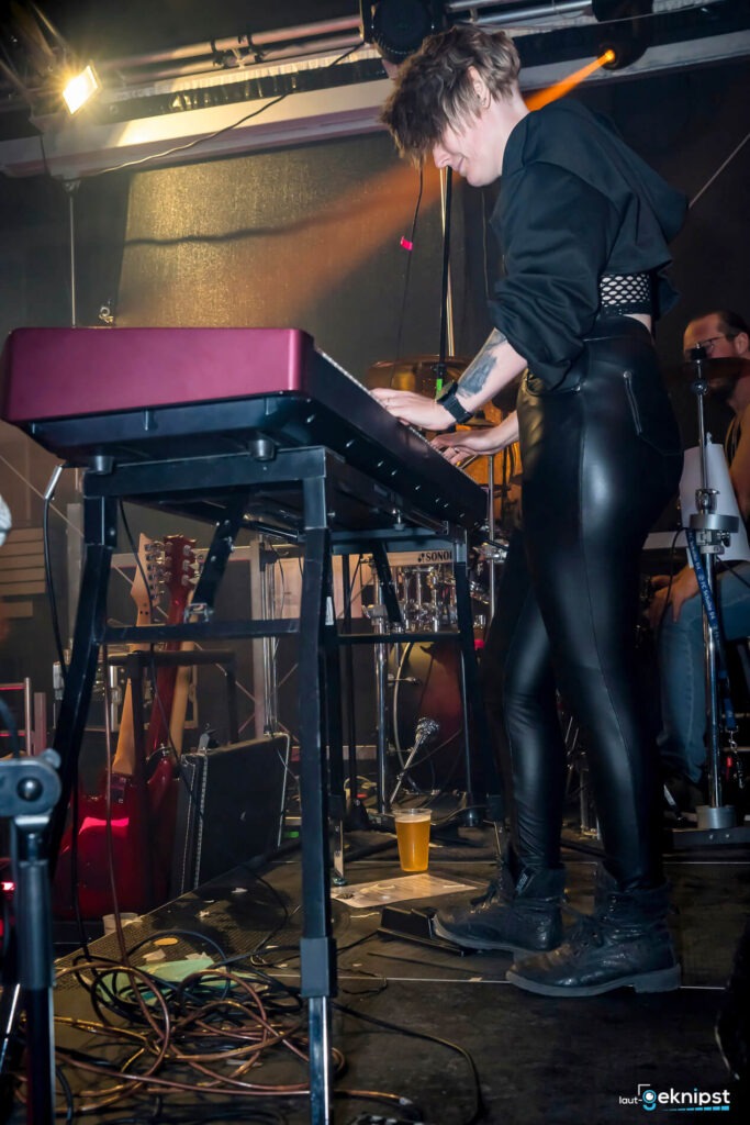 Musikerin spielt Keyboard auf der Bühne