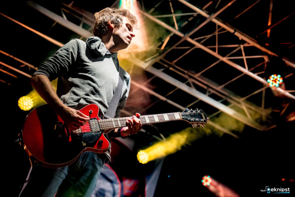 Musiker spielt Gitarre auf der Bühne
