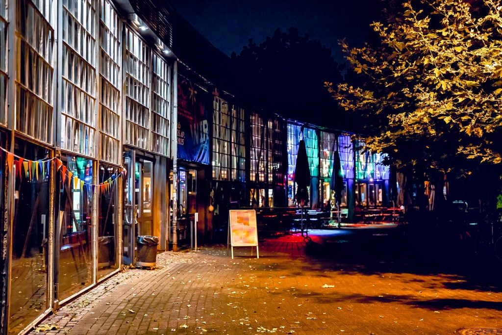 Beleuchtete Straße bei Nacht mit bunten Lichtern.