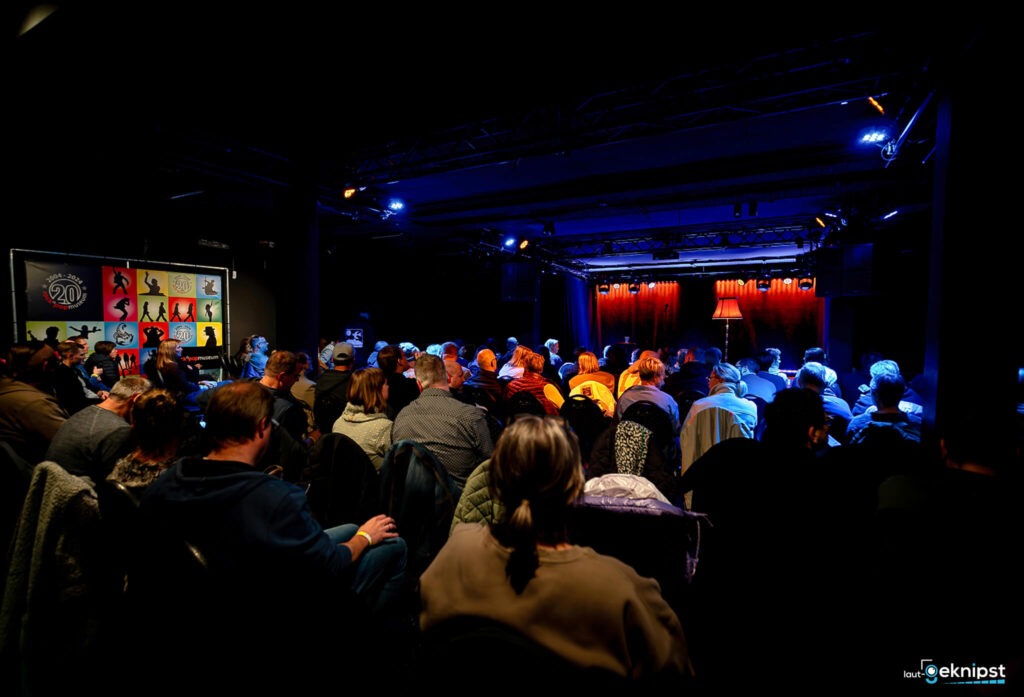 Publikum in einem dunklen Theater mit Bühne